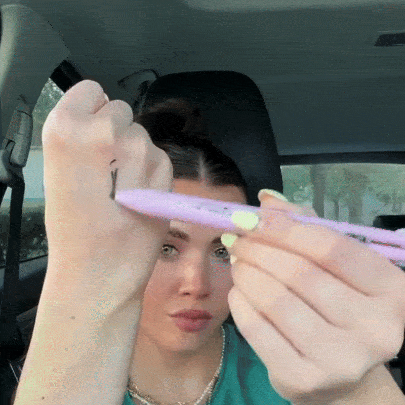 women using 4 in 1 Makeup Pen in car 